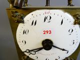 une horloge dorée avec un cadran blanc et des chiffres