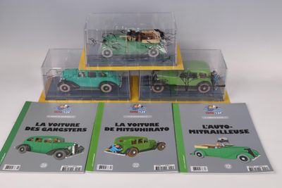 three green toy cars are sitting in a display case on a white surface