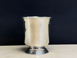 an image of a silver cup sitting on top of a wooden table