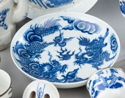 a blue and white plate with a dragon design on it