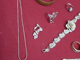 many different types of jewelry on a red surface