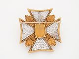 an image of a gold and diamond cross broochle