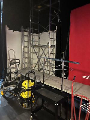 a room with scaffolding on the walls and a chair