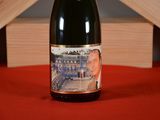 a bottle of wine sitting on a red table cloth
