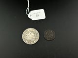 two coins that are next to each other on a table