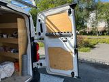 a white van with its door open and a shelf in the back
