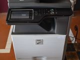 a printer sitting on top of a cabinet in a room