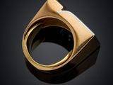 a close up of a gold ring on a black surface