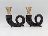 pair of black and gold candlesticks on a white background