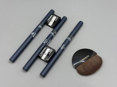 three brushes and a brush sitting on a table