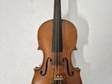 a close up of a violin on a wall with a white background