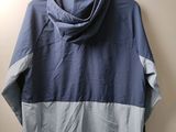 an image of a blue and grey jacket hanging on a wall