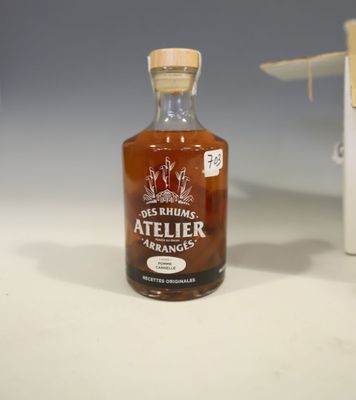 a bottle of alcohol sitting on a table next to a box