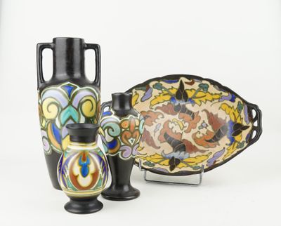 three vases and a plate sitting on a table