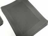 a pile of black fabric on a table next to a cell phone