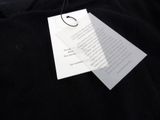 a black shirt with a tag attached to it