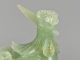 an image of a green bird with flowers on it ' s head