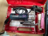 a red tool box with a drill and other tools in it