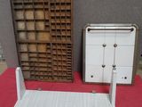 a small shelf and a small cabinet on a red table