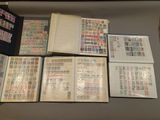 a lot of stamps on a table with a book