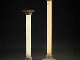 a pair of tall white lamps with a light on top of them