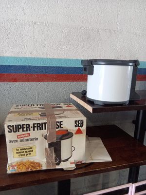 a box of food sitting on a table next to a crock pot