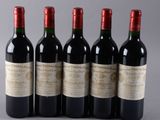 four bottles of wine are lined up in a row