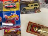 a lot of hot wheels and other toy vehicles on the table