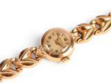 an image of a close up of a wrist watch on a chain