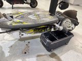 a scooter that is sitting on the floor in the garage