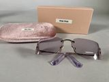 sunglasses and case sitting on a table next to a box