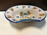 a blue and white bowl with a flower design on it