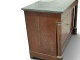 an old wooden cabinet with a marble top