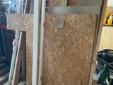several pieces of plywood are stacked on top of pallets in a warehouse