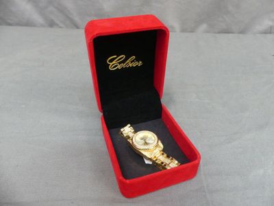 an image of a red box with a gold watch inside of it
