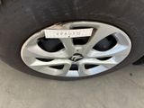the tire of a car with a sticker on it ' s rim
