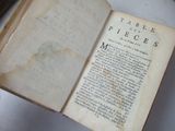 an old book open on a table with a pen in it