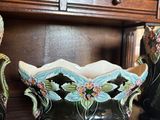 three vases sitting on a shelf with a price tag