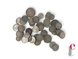 a pile of silver coins on a white surface