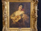 un vieux tableau représentant une femme tenant une guitare, dans un cadre doré