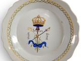 a plate with a crown on it on a white surface