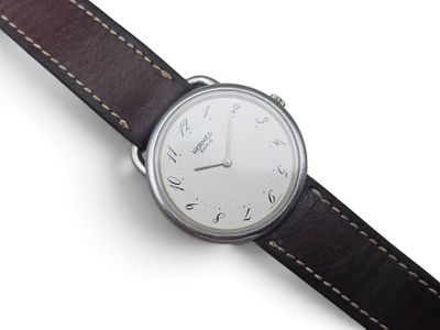 an image of a close up of a wrist watch on a white surface