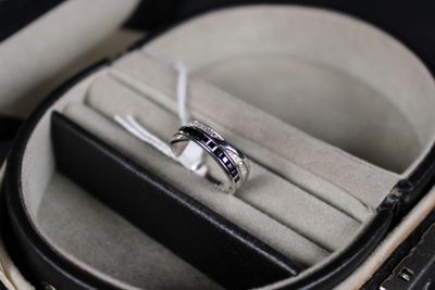 a ring in a case that is sitting on a table