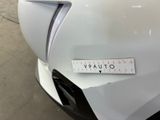 a close up of a white car with a sticker on it