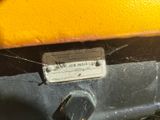 a close up of a yellow car with a spider web attached to the front of it