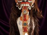 an image of a mask made of feathers and beads