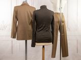 three mannequins are lined up on a stand in front of a white wall