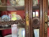 a glass cabinet with a bunch of plates on top of it