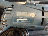 a close up of a drill with a cord on it