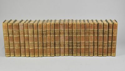 a large collection of old books on a white surface